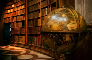 vintage globe in front of bookshelves